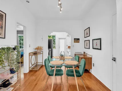a dining room with furniture and wooden floor