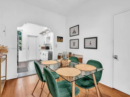 a view of a dining room with furniture and wooden floor
