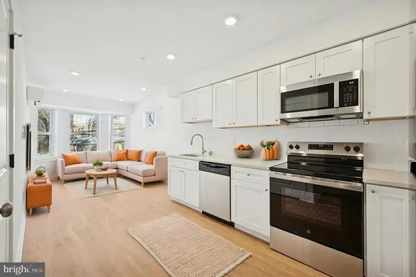 a kitchen with stainless steel appliances a stove microwave and cabinets