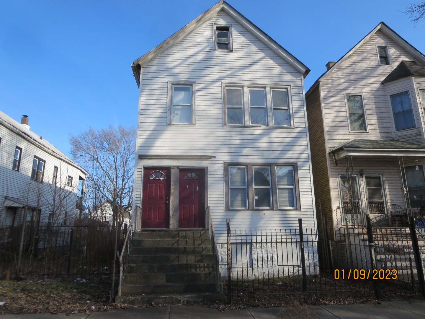 a front view of a house with iron fence
