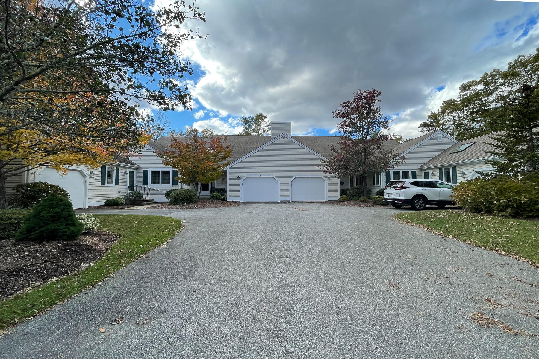 13 North Ridge Road Mashpee, MA 02649 - Photo 4 of 42 a front view of a house with a yard and garage