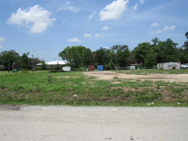 a backyard of a house with lots of green space and lake view