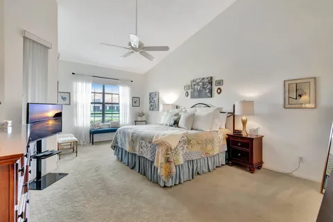 a spacious bedroom with a bed and a chandelier
