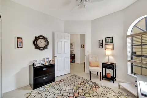 a bathroom with a granite countertop sink mirror vanity and toilet