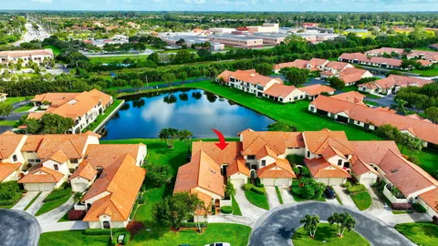 an aerial view of a house with outdoor space and a lake view