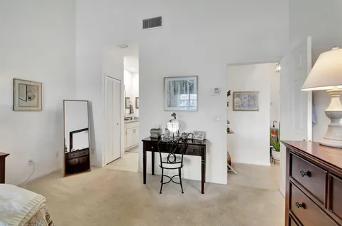 a living room with furniture a dining table and a refrigerator