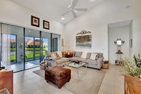 a living room with furniture and a floor to ceiling window
