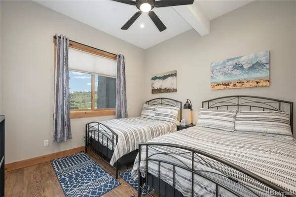 a bedroom with two beds and a chandelier