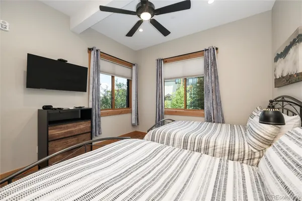 a view of a hallway with wooden floor and furniture