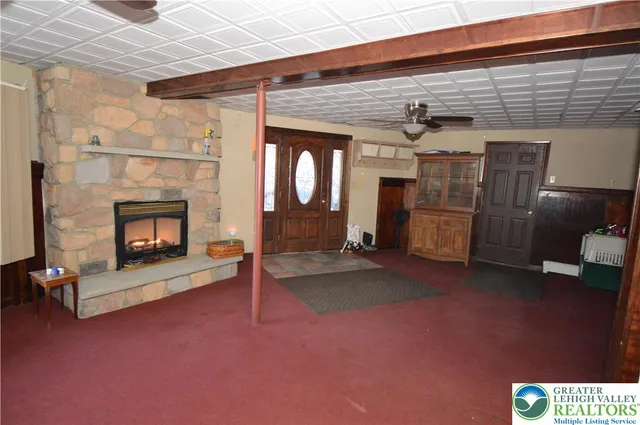 a view of a livingroom with a fireplace and window