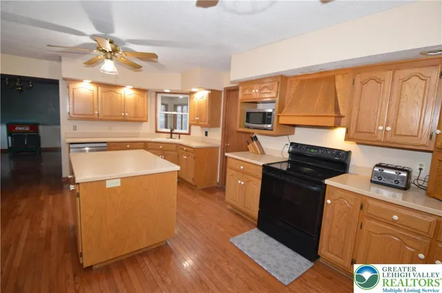 a kitchen with granite countertop a stove top oven and sink
