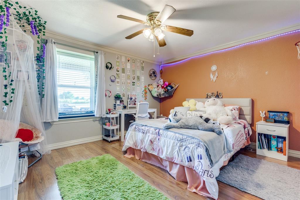 1590 Farm Road 2352 Sumner, TX 75486 - Photo 11 of 40 a bedroom with bed and a chandelier