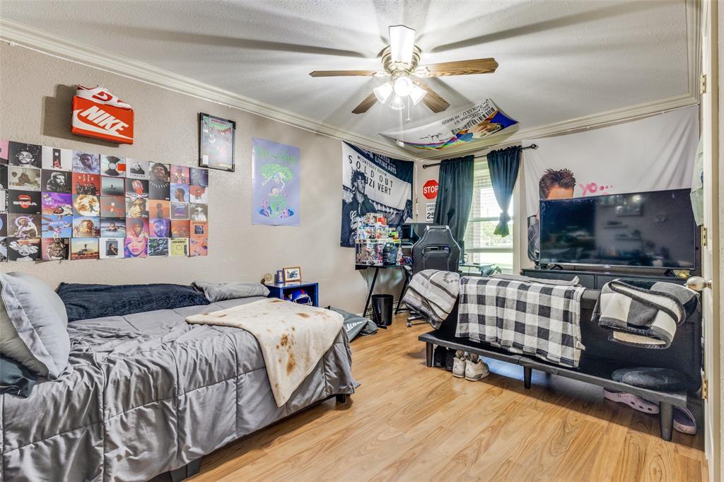 1590 Farm Road 2352 Sumner, TX 75486 - Photo 26 of 40 a bedroom with furniture and a flat screen tv