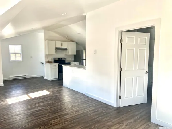 a view of a kitchen with wooden floor and a sink