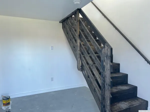 a view of staircase with lots of frames on wall