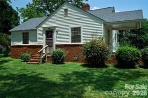 a front view of a house with a garden and plants