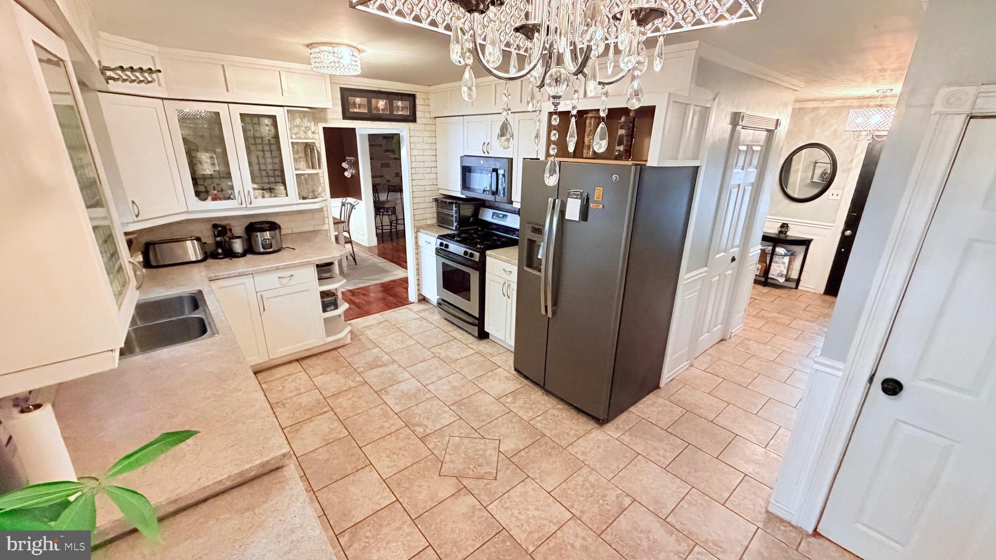 9 East Kennedy Drive Clementon, NJ 08021 - Photo 14 of 60 a kitchen with stainless steel appliances kitchen island granite countertop a refrigerator and a stove