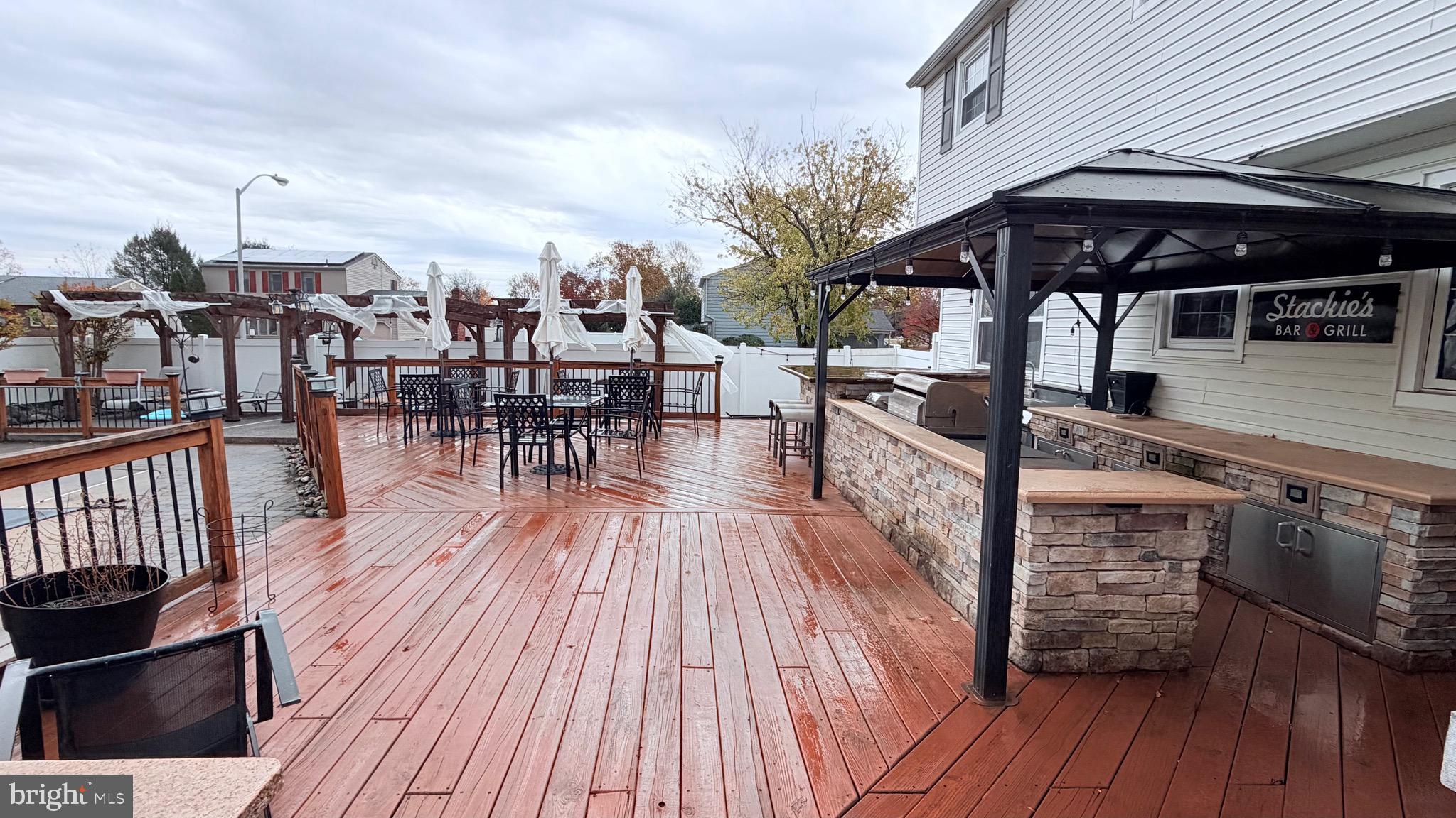 9 East Kennedy Drive Clementon, NJ 08021 - Photo 38 of 60 a view of a roof deck with table and chairs a barbeque with wooden floor and fence