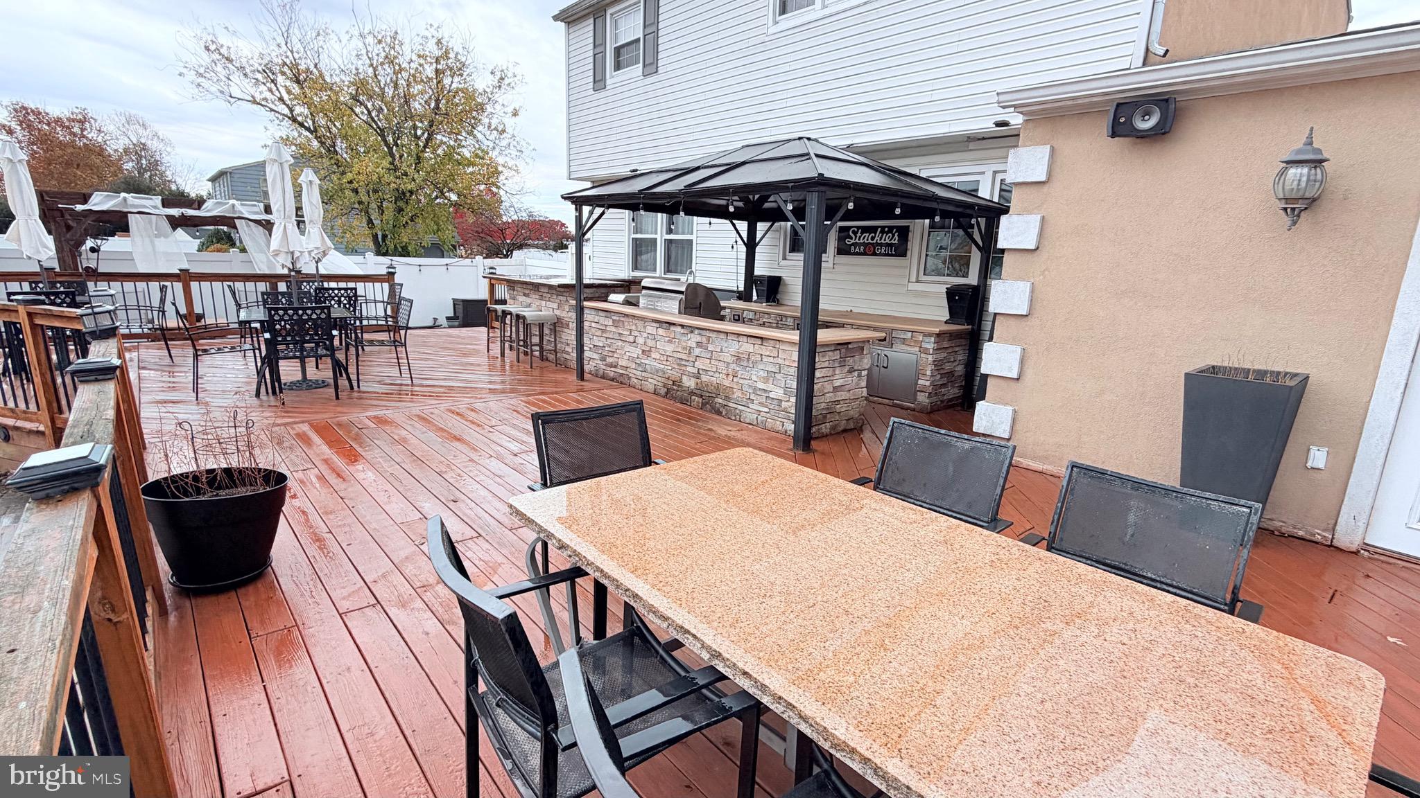 9 East Kennedy Drive Clementon, NJ 08021 - Photo 39 of 60 a view of a patio with table and chairs barbeque potted plants and large tree