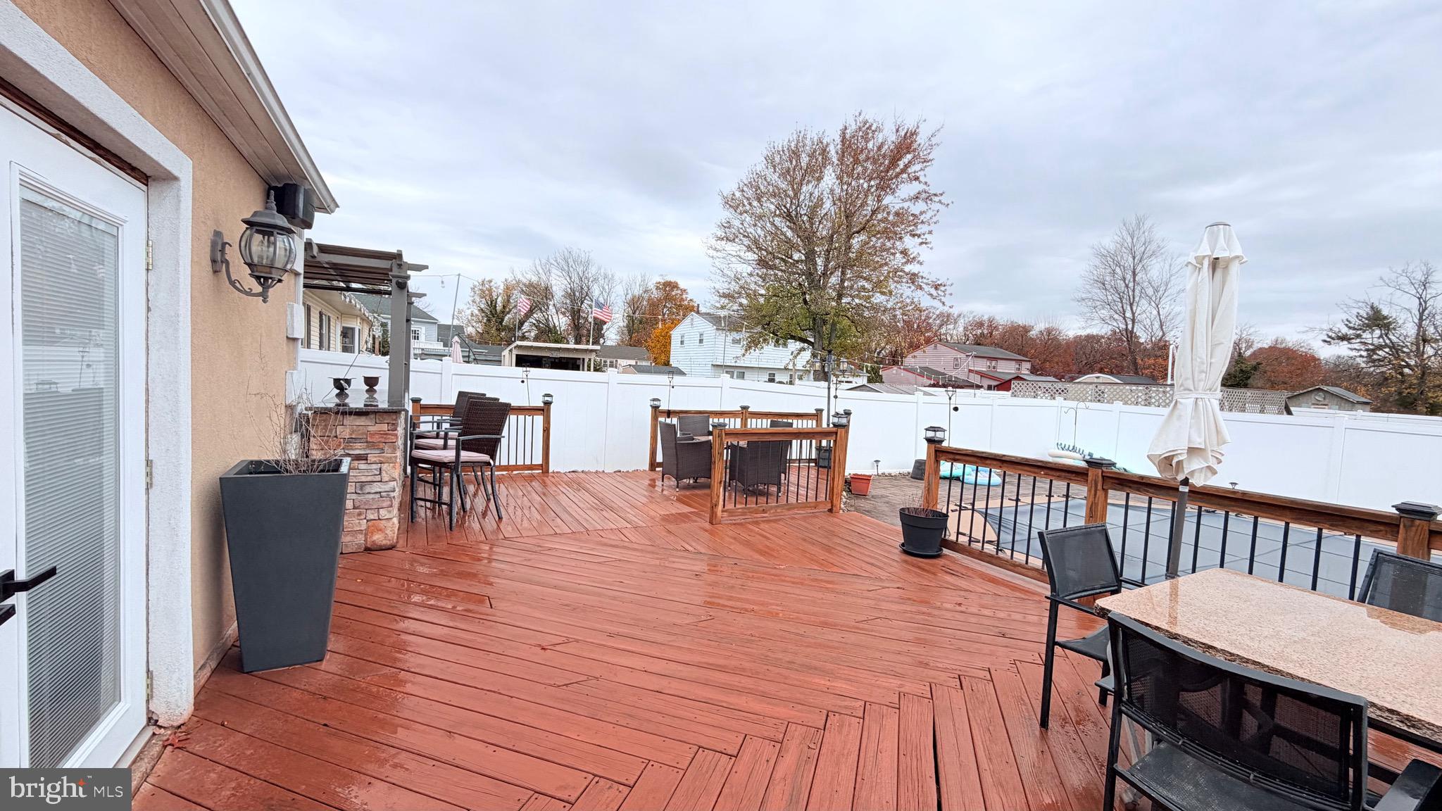 9 East Kennedy Drive Clementon, NJ 08021 - Photo 46 of 60 a view of a patio with dining table and chairs with wooden floor and fence