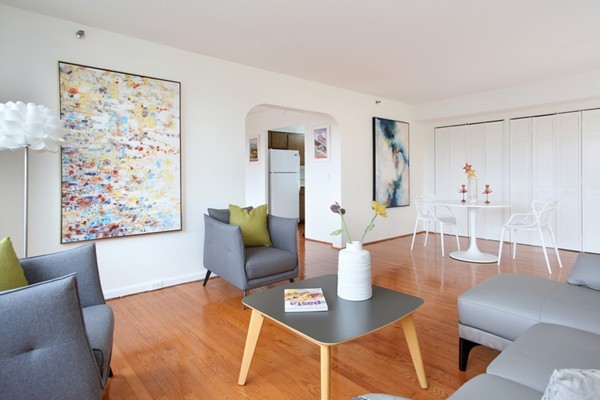 1731 Beacon Street, Unit 512 Brookline, MA 02445 - Photo 2 of 5 a living room with furniture and a large window
