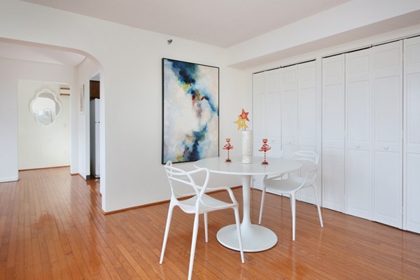 1731 Beacon Street, Unit 512 Brookline, MA 02445 - Photo 3 of 5 a view of a dining room with furniture wooden floor and chandelier