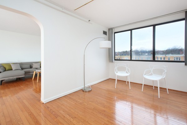 1731 Beacon Street, Unit 512 Brookline, MA 02445 - Photo 4 of 5 a living room with furniture and a large window