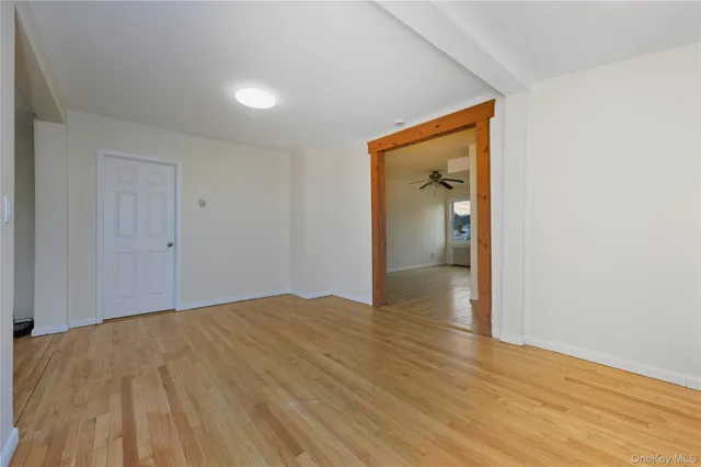 a view of an empty room and wooden floor
