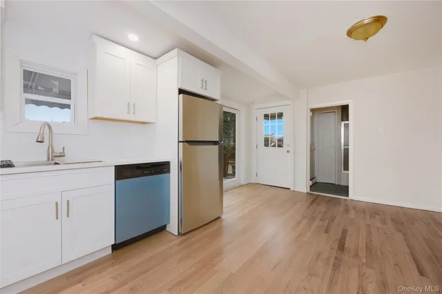 a kitchen with a refrigerator and a sink