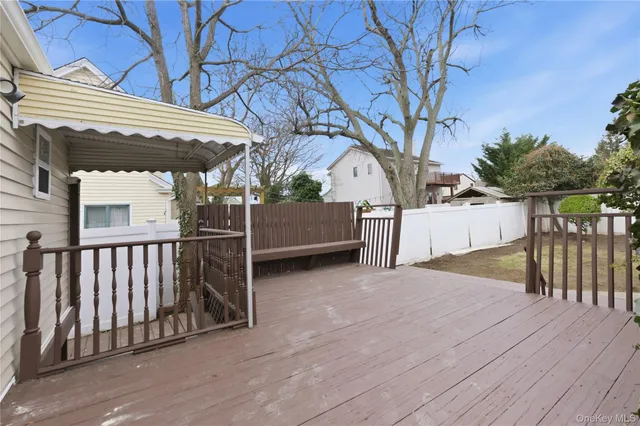a view of backyard with small cabin and wooden fence