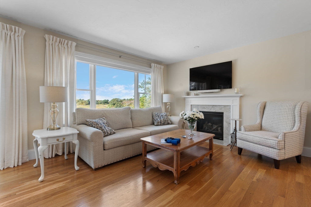 191 Stoney Point Road Barnstable, MA 02675 - Photo 11 of 36 a living room with furniture a fireplace and a flat screen tv