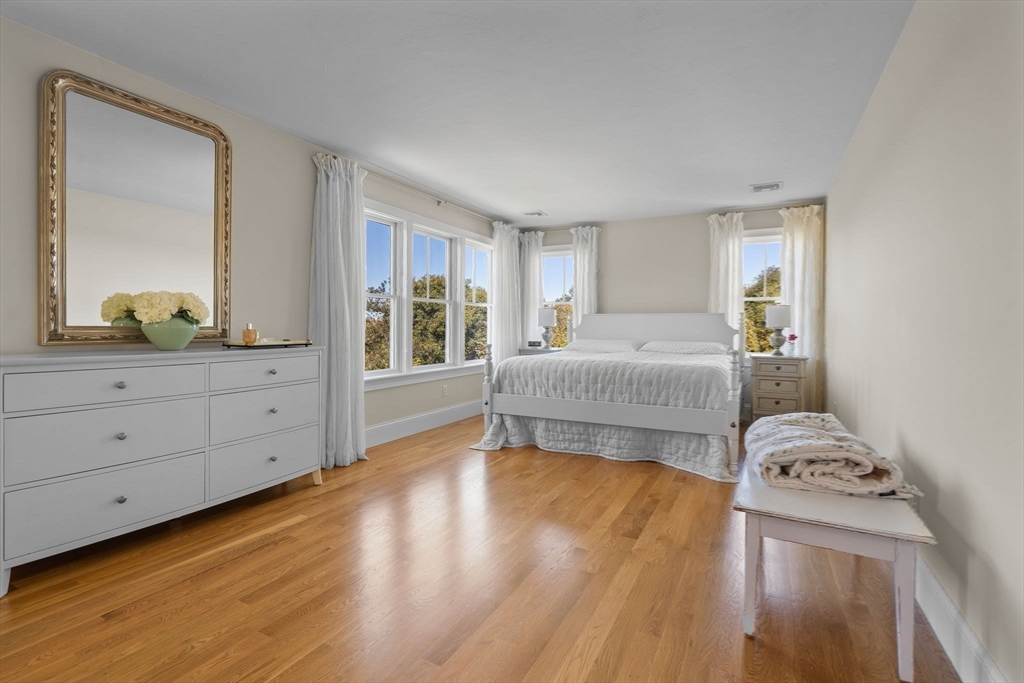 191 Stoney Point Road Barnstable, MA 02675 - Photo 26 of 36 a spacious bedroom with a bed and wooden floor