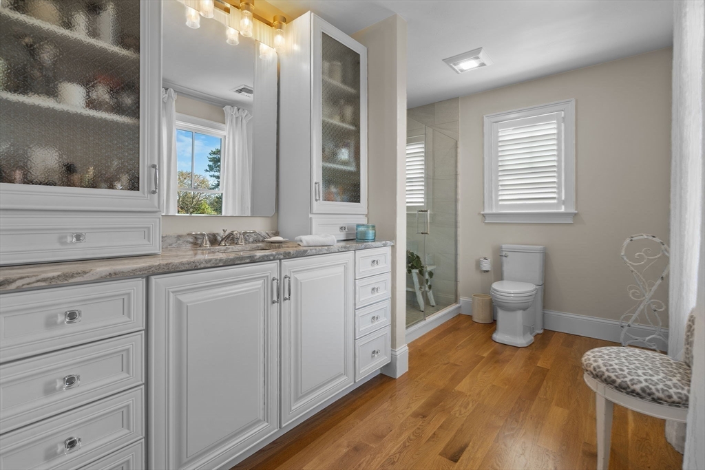 191 Stoney Point Road Barnstable, MA 02675 - Photo 28 of 36 a spacious bathroom with a granite countertop sink a toilet a large mirror and shower