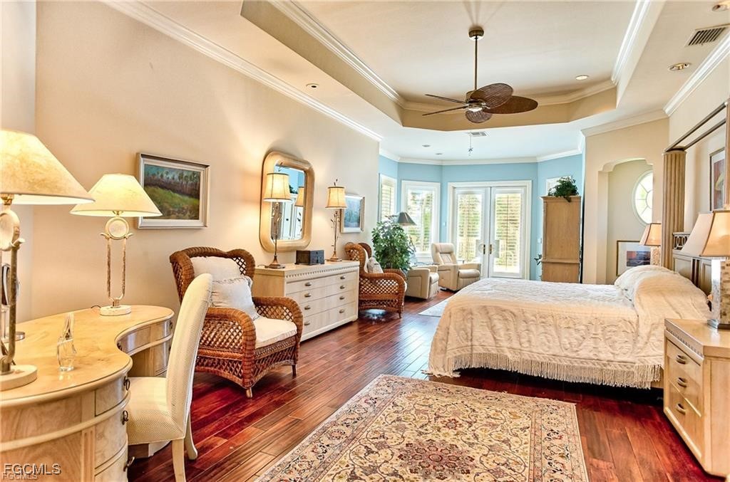 2729 Wulfert Road Sanibel, FL 33957 - Photo 14 of 31 a living room with furniture a wooden floor and a chandelier