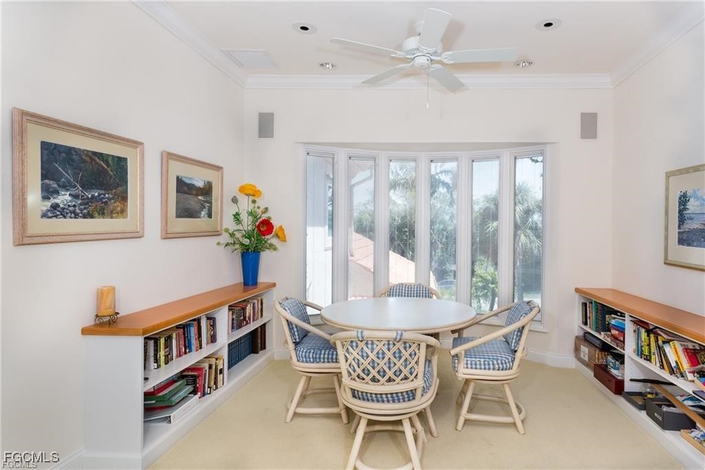 2729 Wulfert Road Sanibel, FL 33957 - Photo 18 of 31 a dining room with furniture a flat screen tv and a chandelier