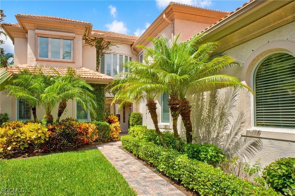 2729 Wulfert Road Sanibel, FL 33957 - Photo 2 of 31 a front view of a house with a yard