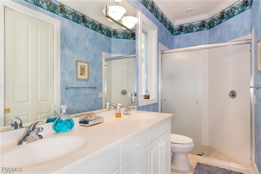 2729 Wulfert Road Sanibel, FL 33957 - Photo 25 of 31 a bathroom with a sink a toilet and shower