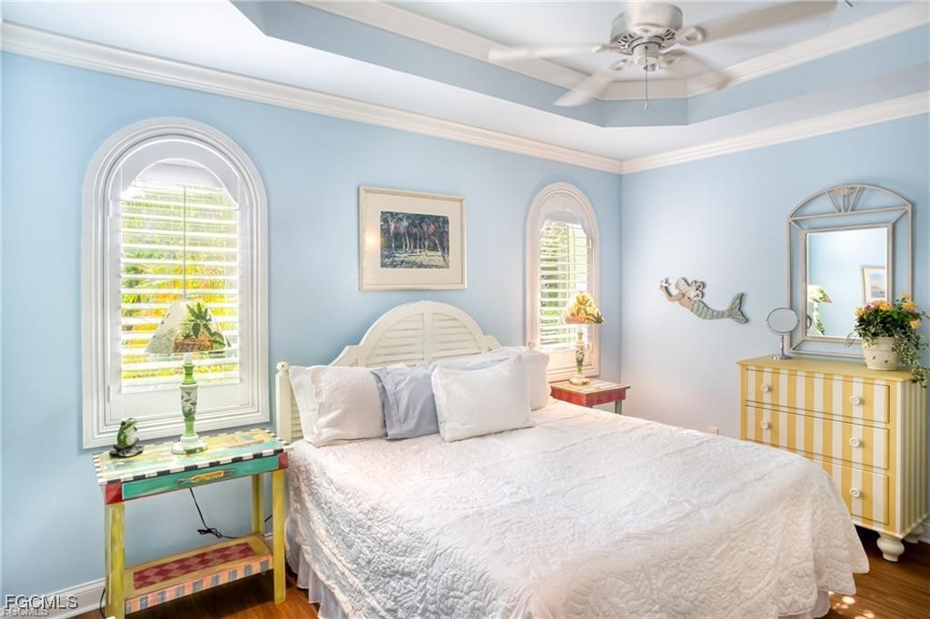 2729 Wulfert Road Sanibel, FL 33957 - Photo 27 of 31 a bedroom with a bed and a chandelier