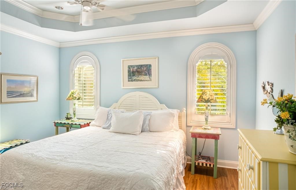 2729 Wulfert Road Sanibel, FL 33957 - Photo 28 of 31 a bedroom with a bed and a chandelier