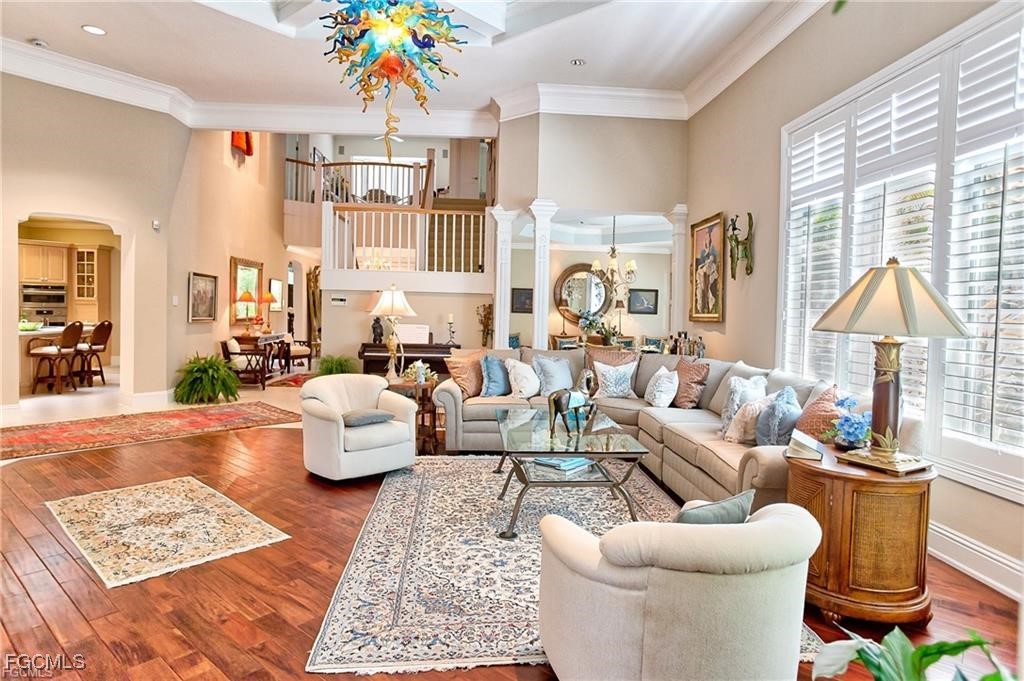 2729 Wulfert Road Sanibel, FL 33957 - Photo 7 of 31 a living room with furniture a rug and a chandelier