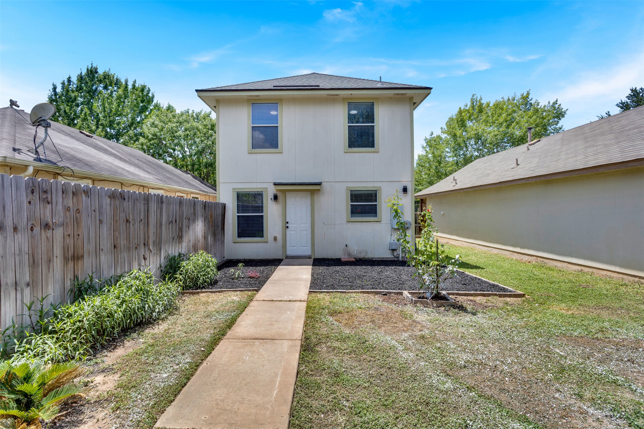 4523 Secure Lane Austin, TX 78725 - Photo 37 of 40 A well-maintained two-story home, nestled in a vibrant neighborhood, offers a fenced yard and tidy landscaping.