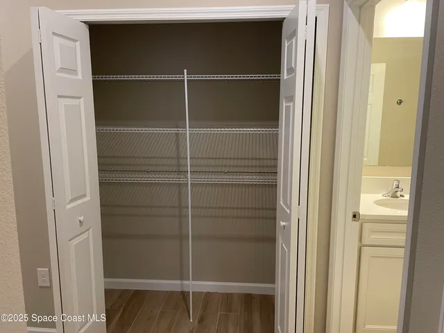 a view of walk in closet with empty racks