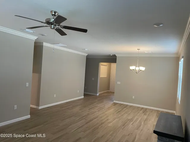 a view of a room with a dishwasher and wooden floor