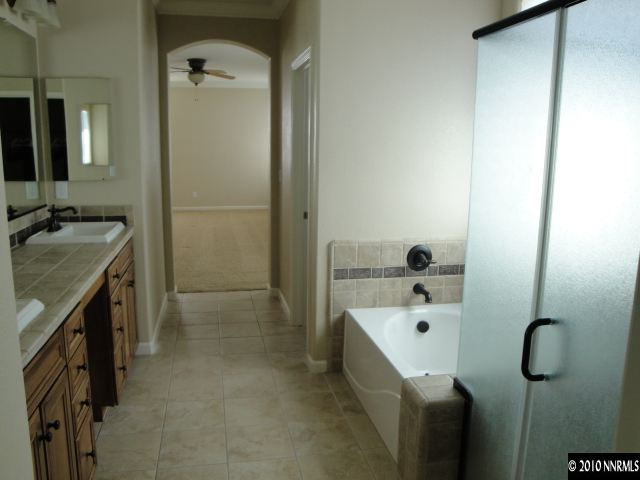 11335 Torino Way Reno, NV 89521 - Photo 6 of 9 a bathroom with a tub sink and mirror
