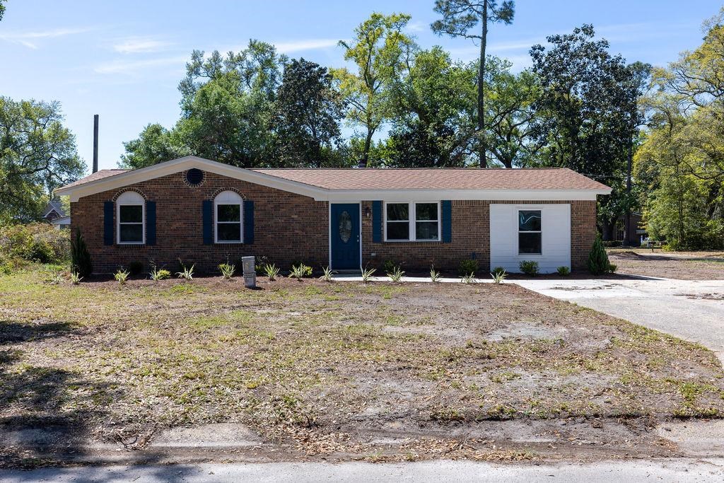 a front view of a house with a garden