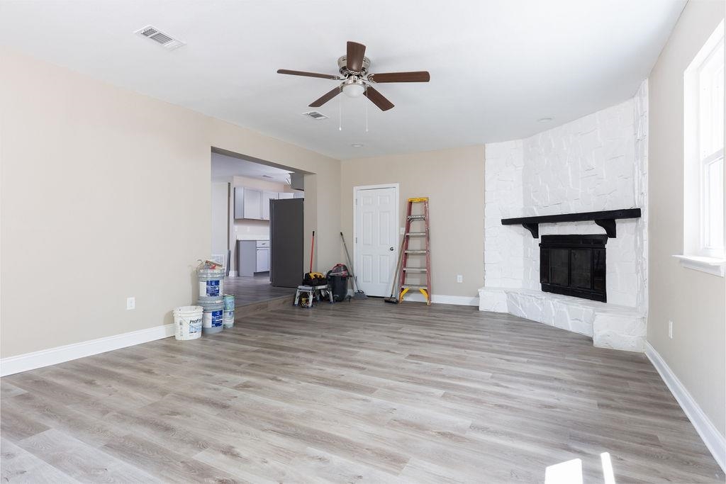 3941 Baybrook Drive Pace, FL 32571 - Photo 11 of 28 a view of a livingroom with wooden floor and a ceiling fan