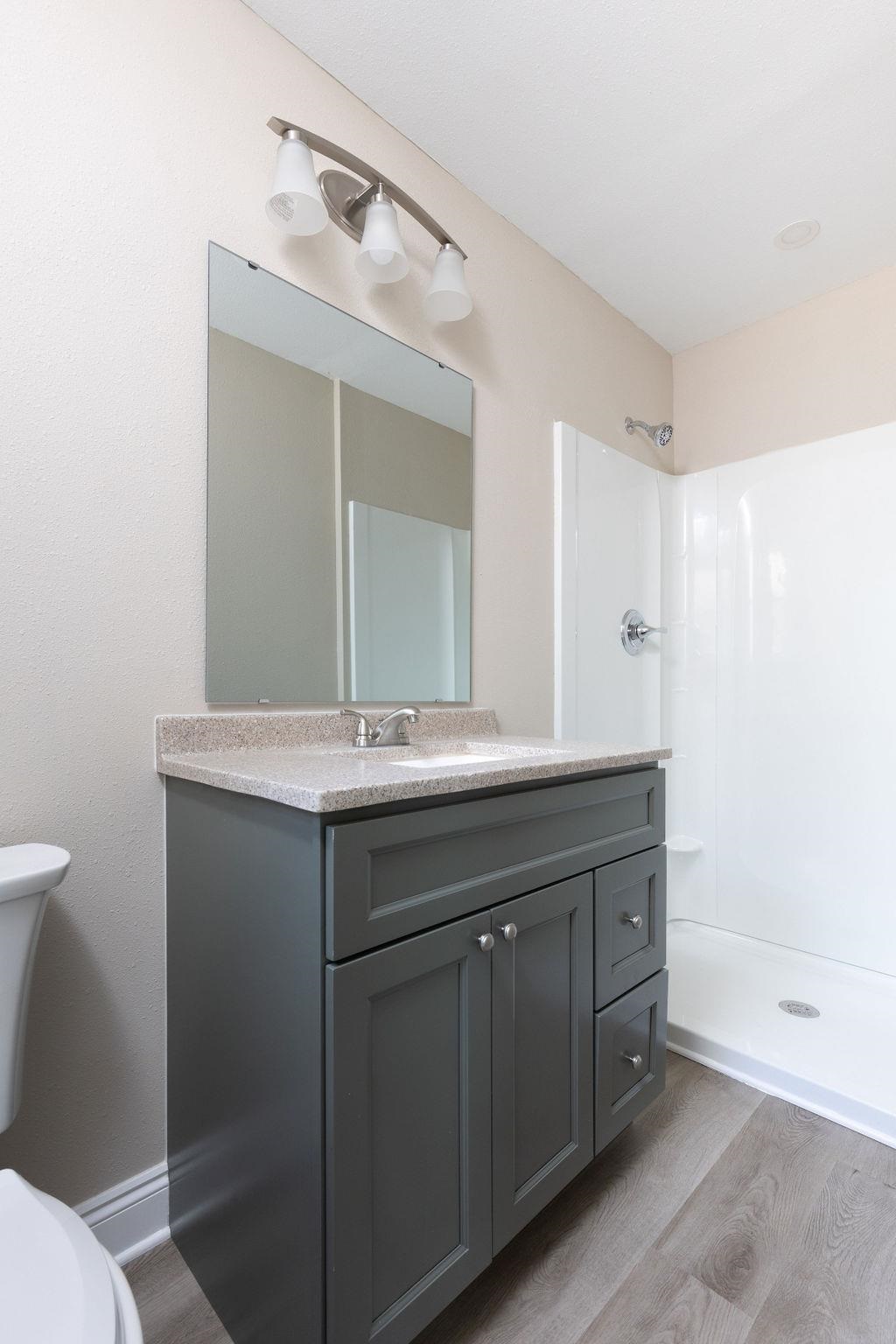 3941 Baybrook Drive Pace, FL 32571 - Photo 14 of 28 a bathroom with a granite countertop sink and a mirror