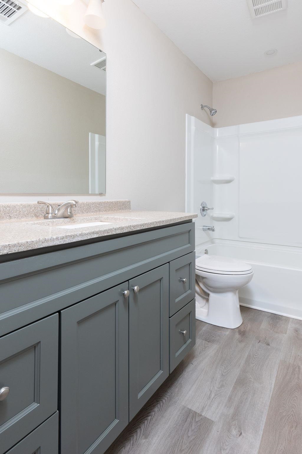 3941 Baybrook Drive Pace, FL 32571 - Photo 17 of 28 a bathroom with a granite countertop toilet sink and mirror