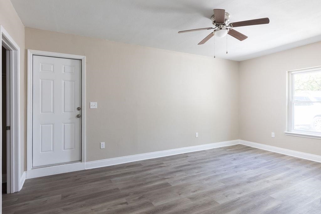 3941 Baybrook Drive Pace, FL 32571 - Photo 18 of 28 a view of a big room with wooden floor and windows in a room