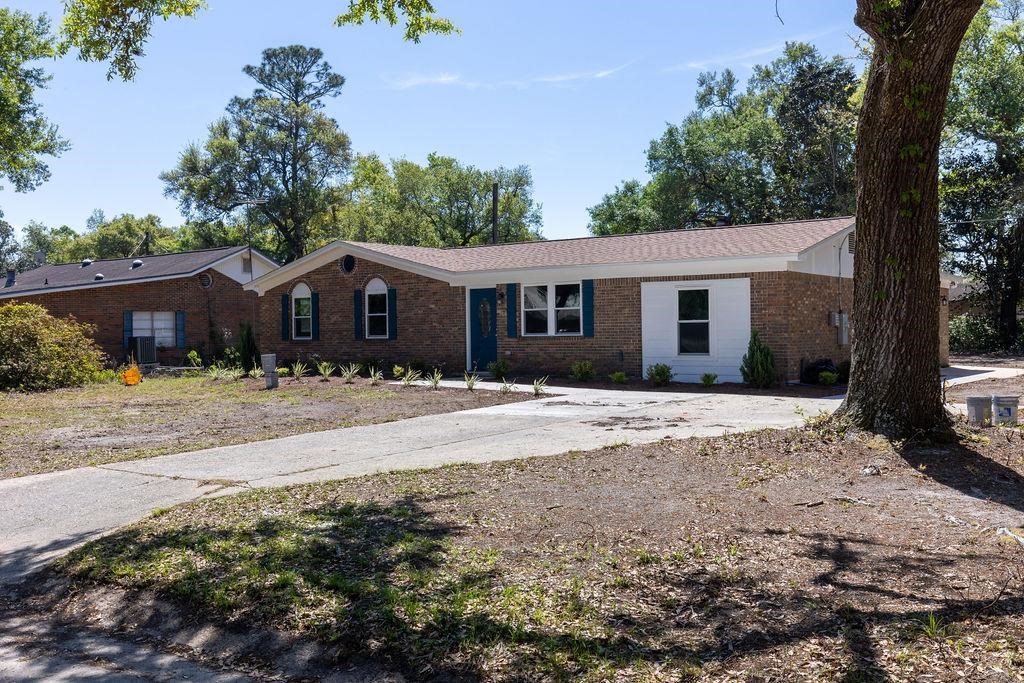 3941 Baybrook Drive Pace, FL 32571 - Photo 2 of 28 a front view of a house with a yard and garage